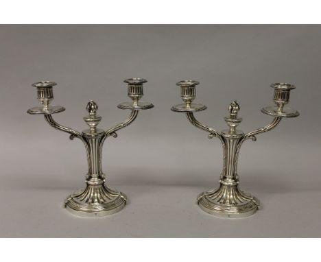 A PAIR OF CHRISTOFLE TWO LIGHT CANDLESTICKS on circular reeded bases. 9.5ins high. 