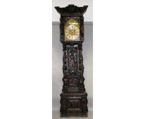 AN IMPOSING CARVED WOOD LONGCASE CLOCK, with brass arched dial, the movement striking on nine bells, signed John Seddan 154. 