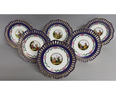 A SUPERB SET OF SIX 19TH CENTURY MEISSEN PORCELAIN PLATES with blue and gilt pierced borders, with ribbons and flowers, the c
