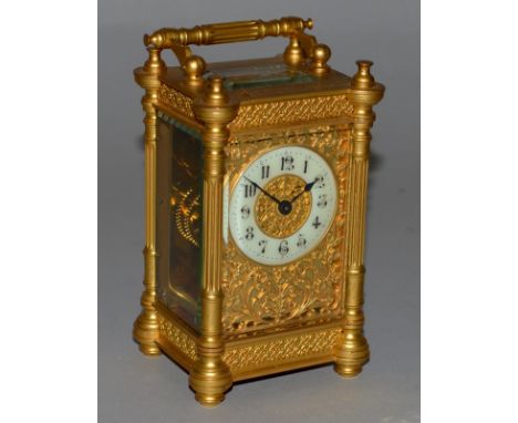 A GOOD 19TH CENTURY FRENCH BRASS FILIGREE CARRIAGE CLOCK with column sides, filigree face. 5ins high, in a leather carrying c