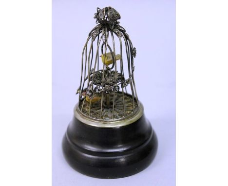 A RARE SMALL SILVER FILIGREE BIRDCAGE CLOCK on a circular wooden base. 5.5ins high. 