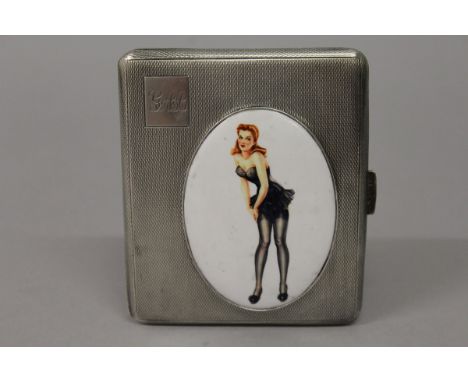 AN ELIZABETH II ENGINE TURNED SILVER CIGARETTE CASE with an oval of a full length young lady adjusting her stockings. Birming