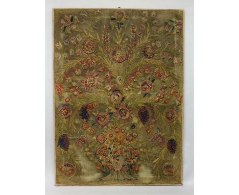 AN UNUSUAL WOOLWORK TAPESTRY PICTURE, portraying a vase of flowers and floral sprays, stretched but unframed. 56.5ins x 41.5i