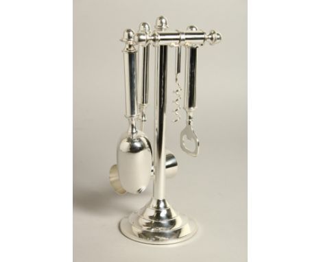 A SILVER PLATED FOUR PIECE BAR TOOLS SET on a stand.