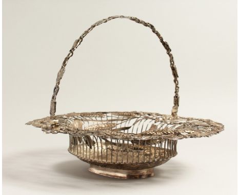 A GEORGE III SILVER WIRE WORK BASKET, oval with fruiting vines an wheat ears with pierced handles. London 1763, maker W R.