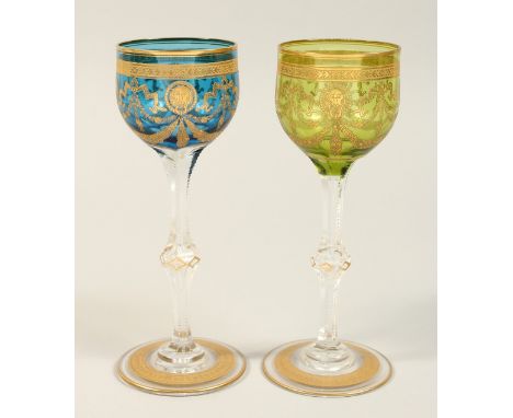 A PAIR OF GILT DECORATED WINE GLASSES. 7.75ins high.