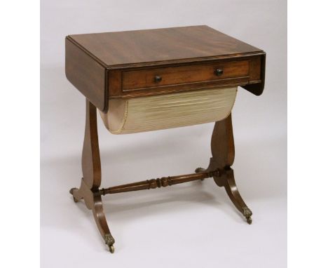 A SMALL REGENCY MAHOGANY DROP LEAF SOFA TABLE - SEWING TABLE with long frieze drawer, end supports, curving legs with claw ca