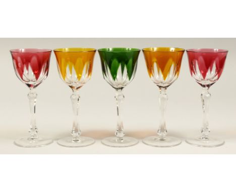 A SET OF FIVE CUT GLASS WINE GLASSES, comprising: a pair of amber tinted, a pair of ruby tinted, a single green tinted. 7.25i