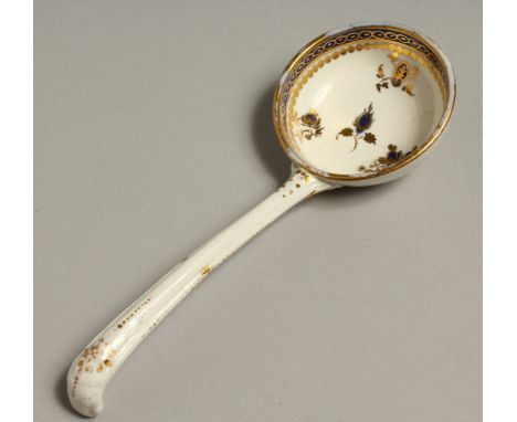 AN 18TH CENTRUY CAUGHLEY LADLE decorated in blue and gilt.