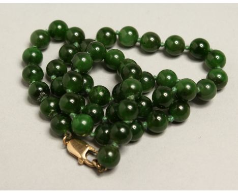 A JADE NECKLACE with gold clasp