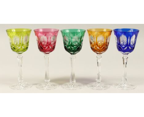 A SET OF FIVE CUT GLASS WINE GLASSES, one green, one bright green, one amber ,one blue,one ruby. 8.5ins high.