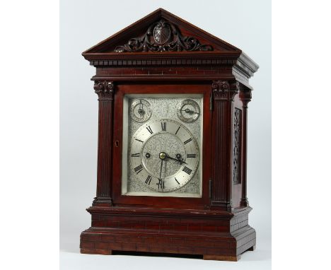 AN EDWARDIAN MAHOGANY MANTLE CLOCK, with eight day movement striking on a gong, engraved silvered dial with subsidiary strike