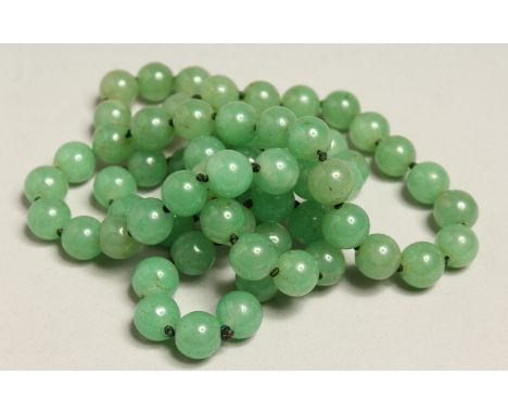 A STRING OF JADE BEADS