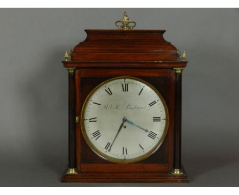 Richard M Lashmar, a George IV mahogany bracket clock, having an ogee bell top with pineapple finials above a circular Roman 