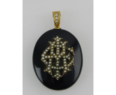 An early 20th century yellow metal mounted portrait pendant (lacking portrait), the black case bearing monogram to verso deco