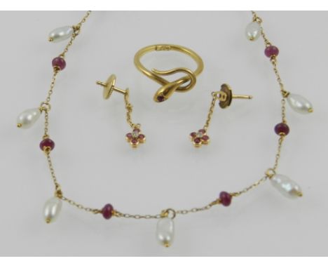 A yellow metal, pearl, and ruby necklace, the chain suspended with  seven pearls and eight small ruby beads, the clasp stampe