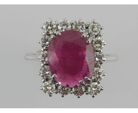 A white metal, diamond, and ruby cluster ring.