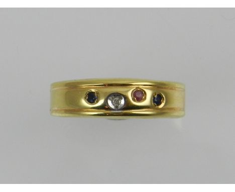 A 14 carat yellow gold ring, set with a small diamond, a ruby, and two sapphires. 
