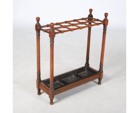 A late 19th century mahogany stick stand, of rectangular form, the upper section with twelve square shaped divisions supporte