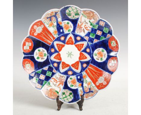 A Japanese Imari chrysanthemum shaped dish, late Meiji Period, decorated with a central seven petalled flower within a panell