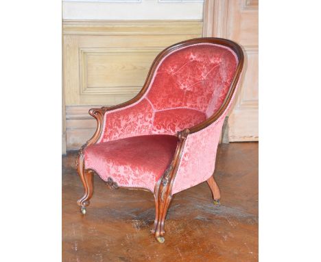 A Victorian mahogany parlour chair, the button down velvet upholstered back, arms and seat raised on foliate and scroll carve