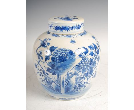 A Chinese porcelain blue and white jar and cover, Qing Dynasty, decorated with rockwork, peony, bird and butterfly, four char