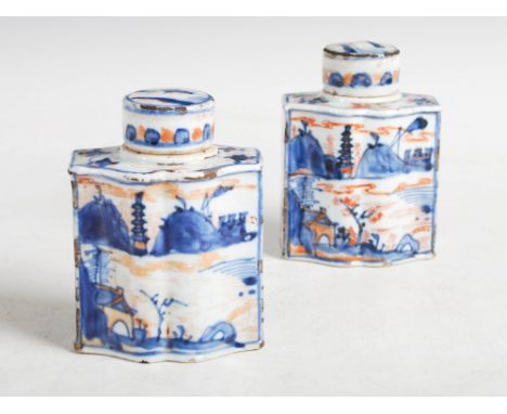 A pair of Chinese porcelain Imari tea caddies and covers, Qing Dynasty, of serpentine rectangular form decorated with pavilio