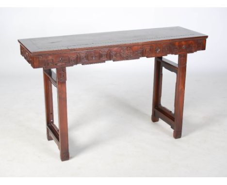 A Chinese dark wood altar table, early 20th century, the rectangular panelled top above a frieze centred with a Shou characte