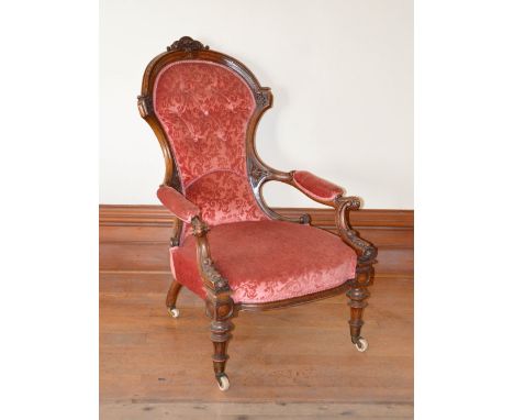 A Victorian walnut parlour chair, the velvet upholstered button down back, arms and seat raised on tapered cylindrical suppor