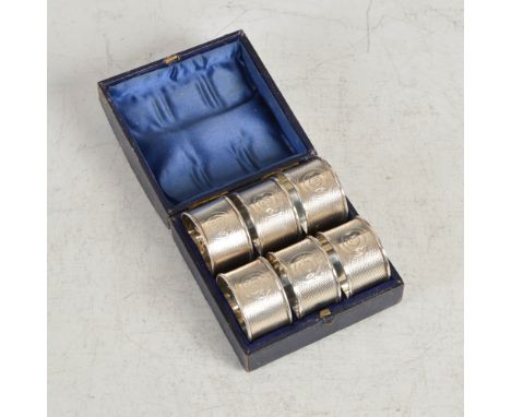 A set of six Victorian silver napkin rings, Birmingham, 1864, makers mark of AT, numbered 1 to 6 within circular shaped carto
