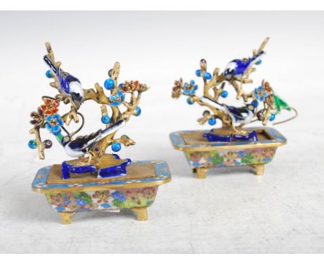 A pair of Chinese cloisonne, ormolu and enamel miniature trees, late 19th/ early 20th century, the flowering branches with co