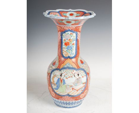 A Japanese Imari vase, Meiji Period, decorated with two shaped panels of figures on a terrace under blossom trees, divided by