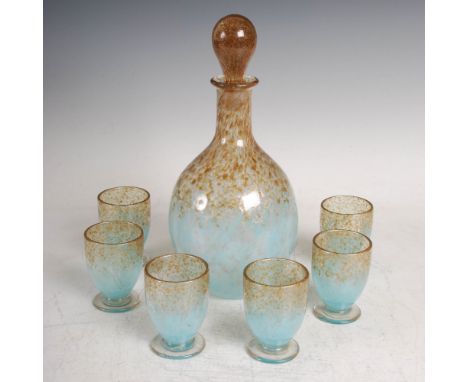 A rare Monart decanter and stopper with six liqueur glasses, mottled clear and pale blue glass with gold inclusions, the glas