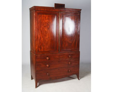 A 19th century mahogany and ebony lined linen press, the moulded cornice centred with a rectangular tablet, above a pair of p