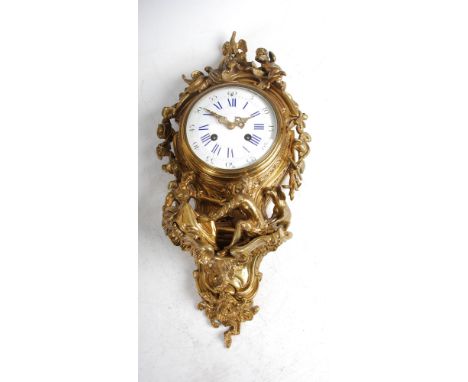 A 19th century French Rococo style ormolu cartel clock, the slightly convex white enamel dial with Arabic and Roman numerals,