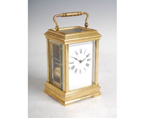 A late 19th/ early 20th century French repeating carriage clock, the white enamel dial with Roman numerals, the twin train mo