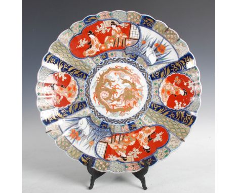 A Japanese Imari chrysanthemum shaped charger, Meiji Period, decorated with a central circular panel enclosing a gilded drago