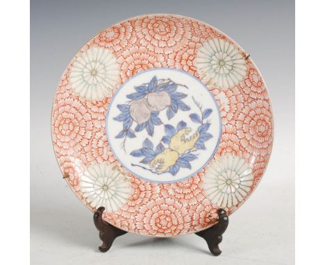 A Japanese Imari dish, Meiji Period, decorated with a circular panel enclosing pomegranates and finger citrus, within a borde