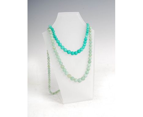Two jade single strand graduated bead necklaces, one strand of rich green colour, 43.5cm long, the other a paler celadon colo