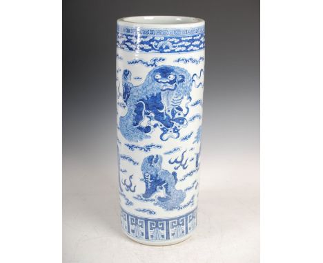 A Chinese porcelain blue and white stick stand, Qing Dynasty, decorated with seven shishi on a ground of cloud scrolls, withi