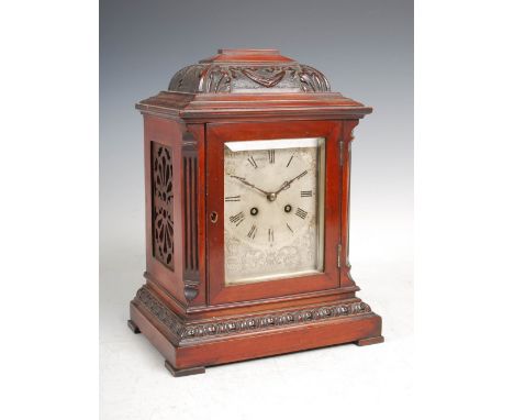 A late 19th century mahogany bracket clock, the silvered dial with Roman numerals and engraved foliate decoration, the twin t