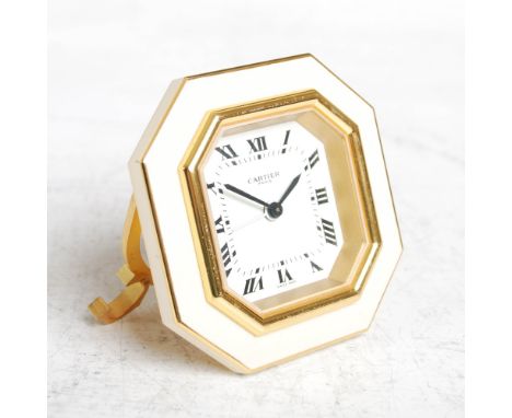 A gilt metal and enamel Cartier octagonal shaped alarm clock, with Roman numeral dial and cream enamelled border, impressed m