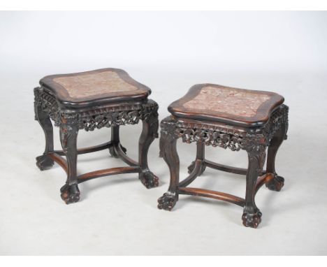 A pair of Chinese dark wood jardiniere stands, Qing Dynasty, the shaped square tops with red and white marble inserts, above 