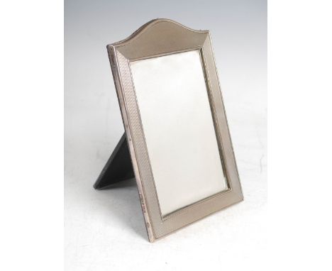 A mid 20th century silver photograph frame, Birmingham, 1963, makers mark of HCD, with engine turned border, 13cm wide x 19cm