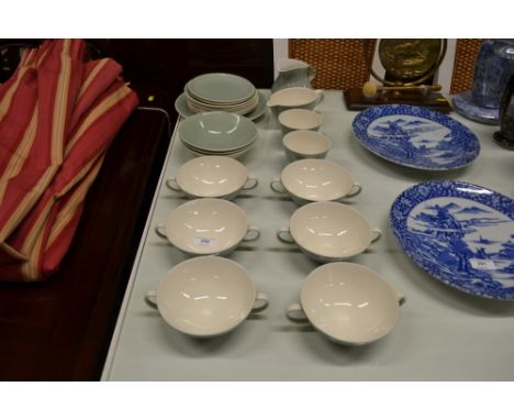 A quantity of Poole pottery soup bowls and saucers etc.