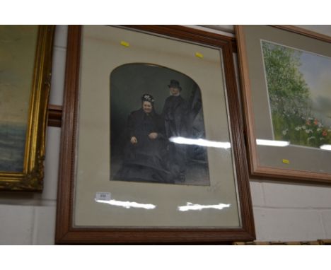 A Victorian over painted portrait of an elderly lady and gentleman 