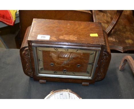 An oak cased three hole mantel clock 