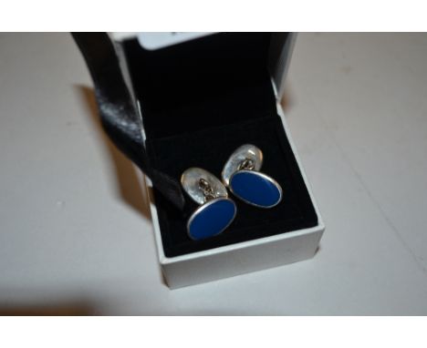 A pair of silver and blue enamel decorated cuff-links 