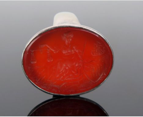 A Large Carnelian Seal Ring in an unmarked precious white metal mount, the 28x21.5mm matrix profusely decorated with JUSTICE 