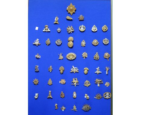 A collection of British and Commonwealth army cap badges including The King's Own, Lancashire Fusilliers, The West Riding, Co
